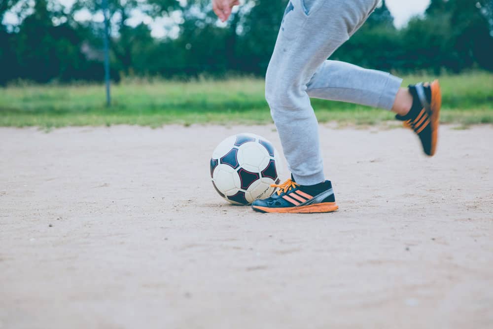 boy kicking soccer ball