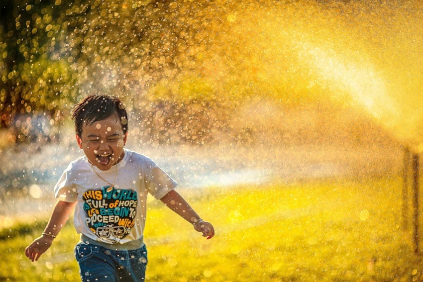 boy playing sprinklers