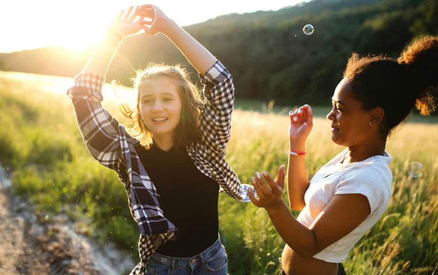 two girls playing bubbles